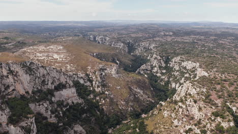 bird's eye view of valley between the rocky canyon of cavagrande del cassibile nature reserve in syracuse, sicily, italy