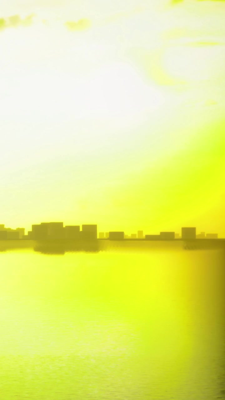 Sunset over city skyline with reflection on water during the evening