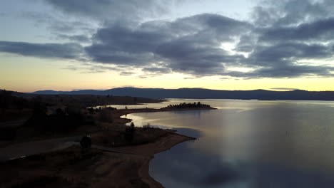 scenic cloudscape reflection on calm lake in jindabyne, new south wales, australia during sunset