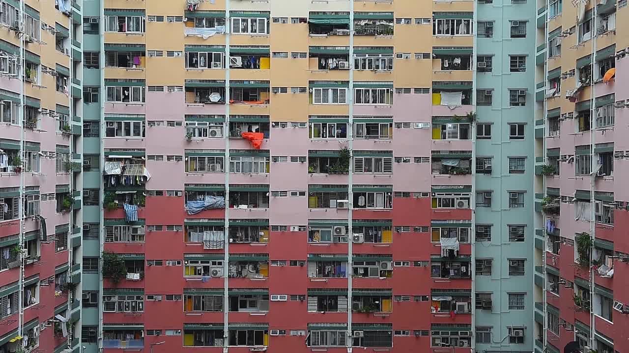 Facade of dense apartment buildings in Kowloon, Hong Kong, showcasing the high-rise architecture, urban density, and vertical cityscape that define one of the most populated areas in the world
