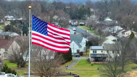 aerial establishing shot of an american flag waving