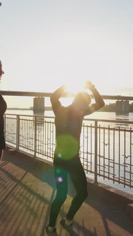 happy people jumping at sunrise by the river