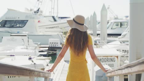 rear view of a teenage caucasian girl enjoying harbor side