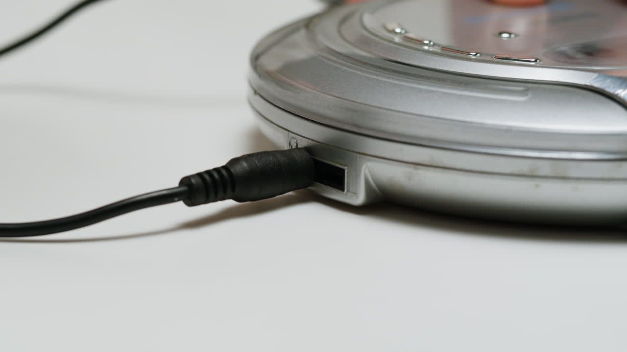 Using headphone for old music portable compact player close-up. Listen to music with vintage player.