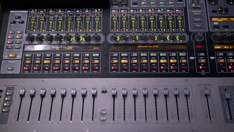 Colorful-dancing-indicator-lights-and-levers-on-a-mixing-board