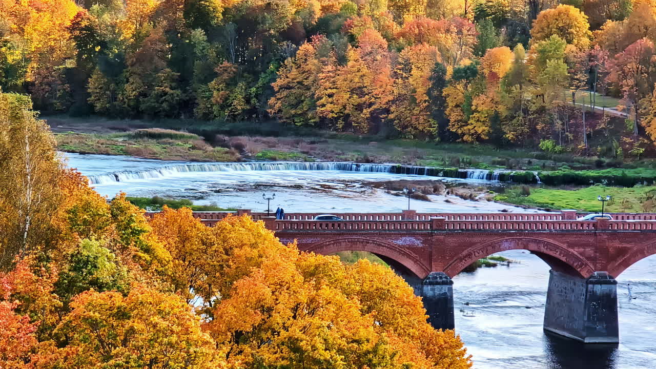Old Brick Bridge across the Venta river Kuldiga Latvia autumn fall season nature landscape