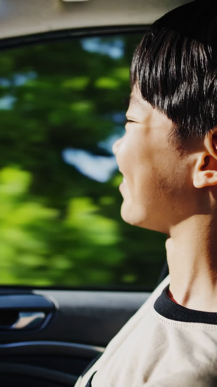 Young Person Looking Out Car Window on a Journey