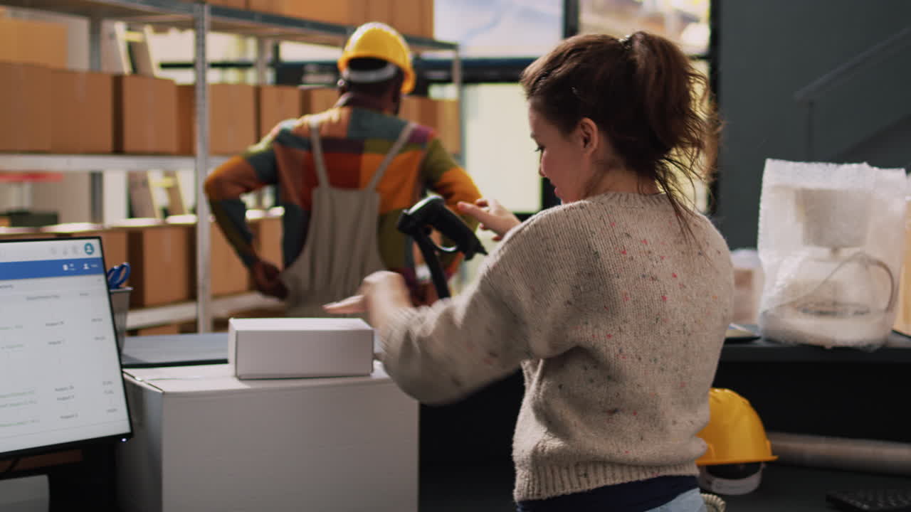 Warehouse workers scanning packages for shipping