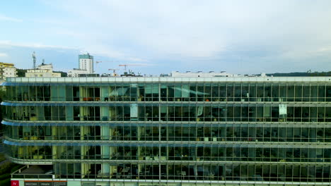 office desk of company seen through glass walls of ppnt building in gdynia, poland