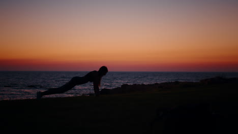 woman exercising at sunset on the beach