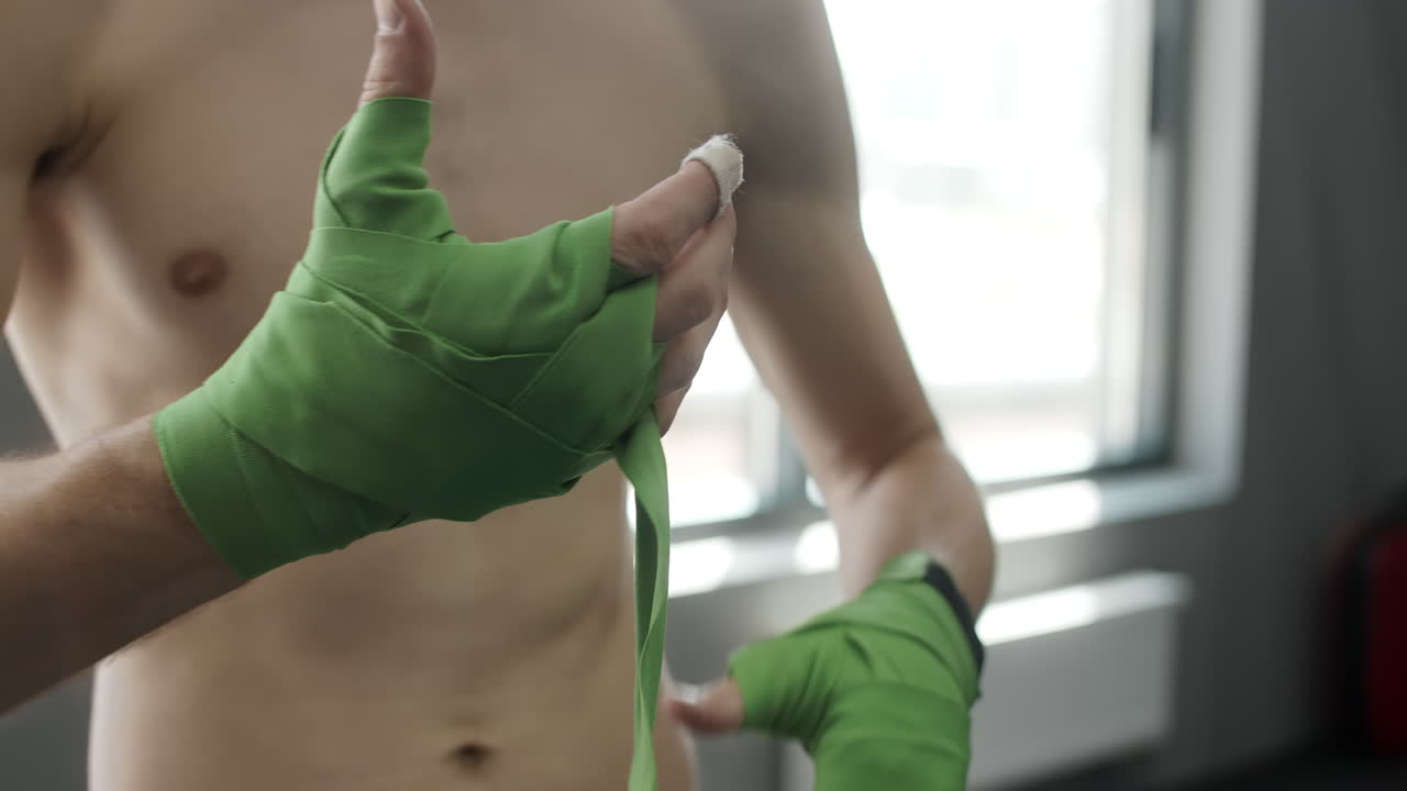 Man Putting on Boxing Wraps