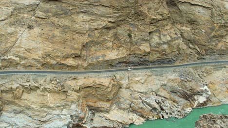 static aerial view of jsr road with vehicles driving on it in skardu, pakistan