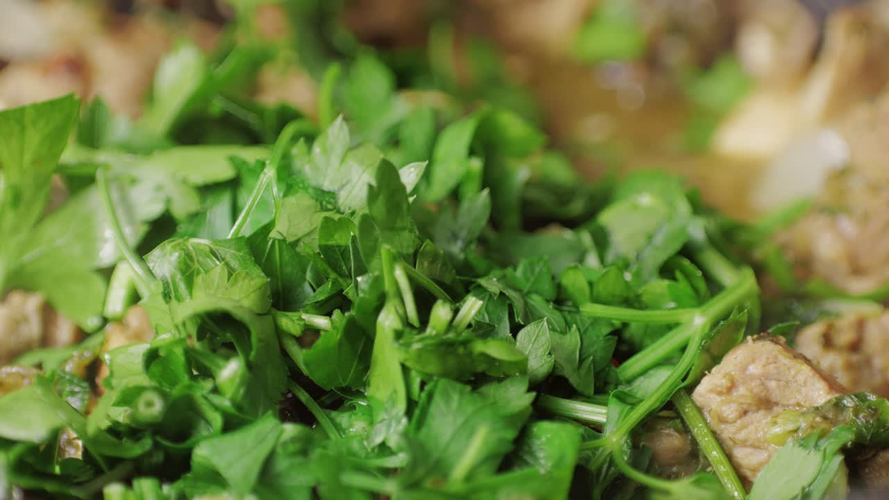 Chicken or pork stew with red and green pepper onion, and spices cooking in a frying pan. Traditional mexican cuisine, tacos preparation, ragout.