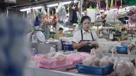 elderly woman working at a local asian market