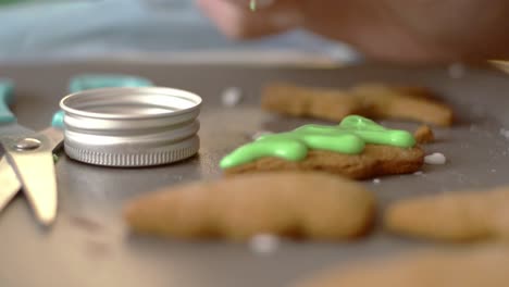 Decorating-gingerbread-Christmas-cookies-with-sugar-icing-and-candies,-close-up-isolated-shot-4k