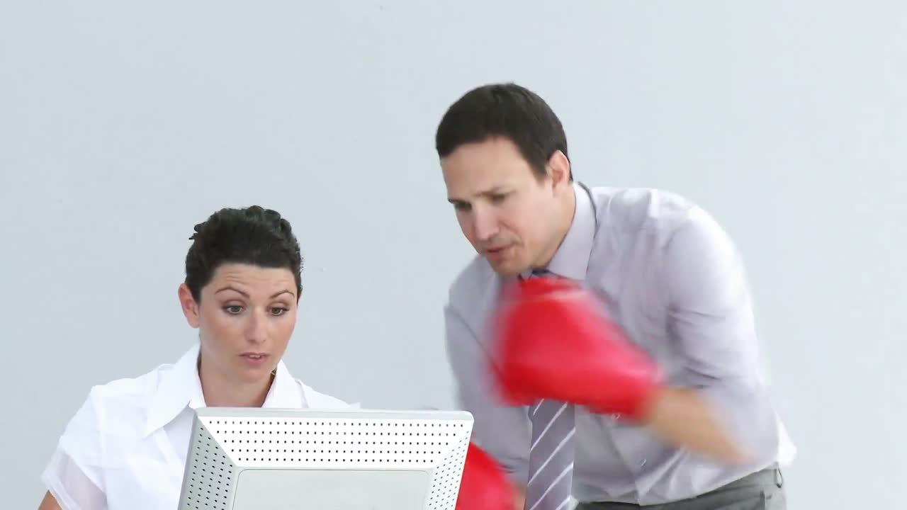 gerente furioso usando guantes de boxeo hablando con su colega