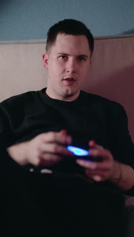 man playing video games on a couch