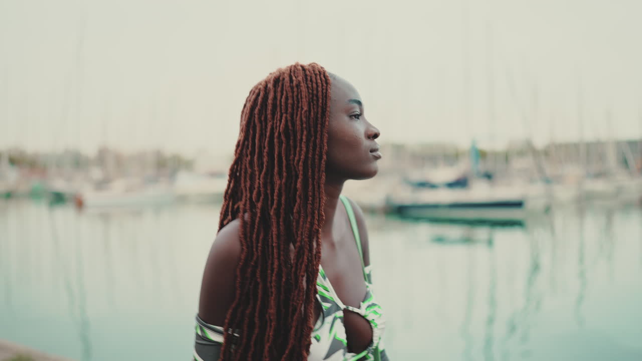 Woman with dreadlocks at the marina