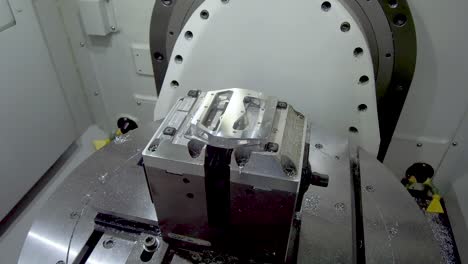 metal part installed in machine holders. work space of the cnc milling center