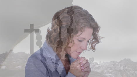 praying woman with rosary beads and cross animation over serene landscape