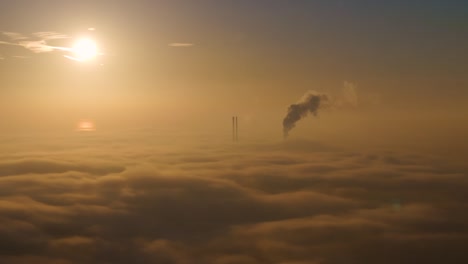 sunset over industrial landscape with fog