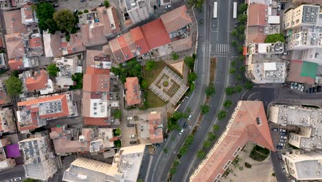 Top-shot-of-empty-Agripas-street-in-Jerusalem-city,-tall-buildings,-shot-with-drone