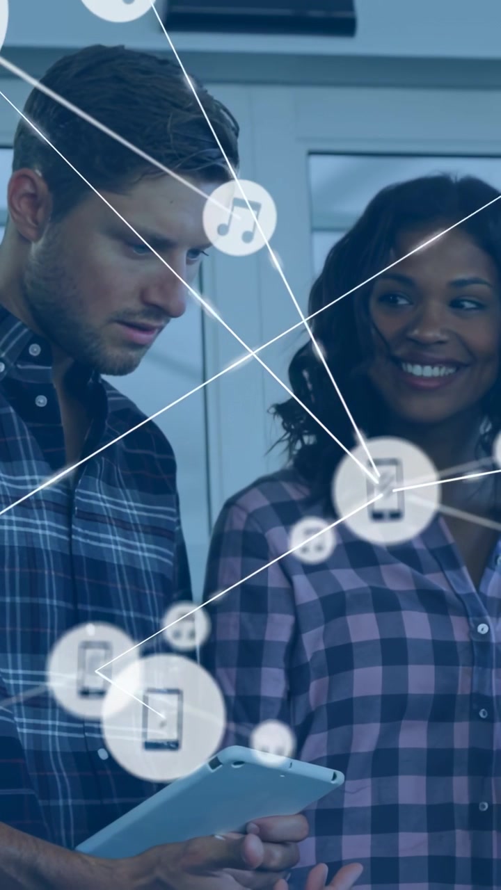 Vertical video: Lead tapping tablet, team watching, phone and music nodes surging for business