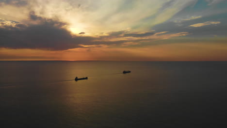 amazing sunset at the north sea with two big ships sailing out