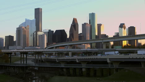 reveal shot of downtown houston, texas and cars on i-45 north freeway