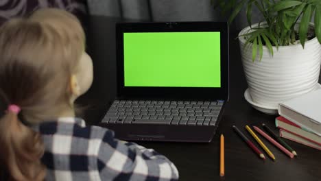 Girl-distance-education-lesson,-using-digital-laptop-at-home.-Green-screen