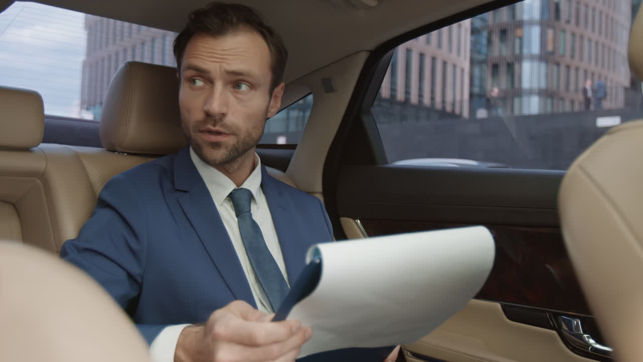 CEO Looking Through Documents in Car
