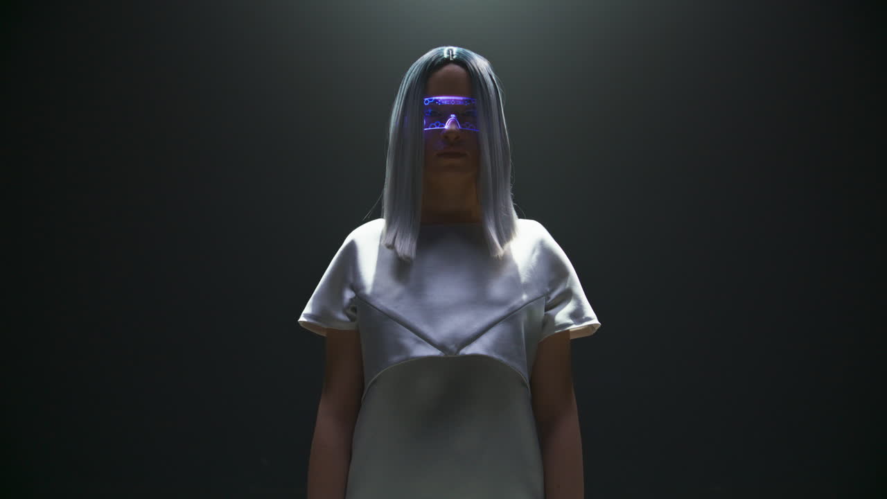 Girl wear holographic glasses at dark background closeup. Virtual reality player
