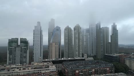 high-rise residential buildings and luxury hotels under foggy sky due to climate change, buenos aires, argentina, drone shot