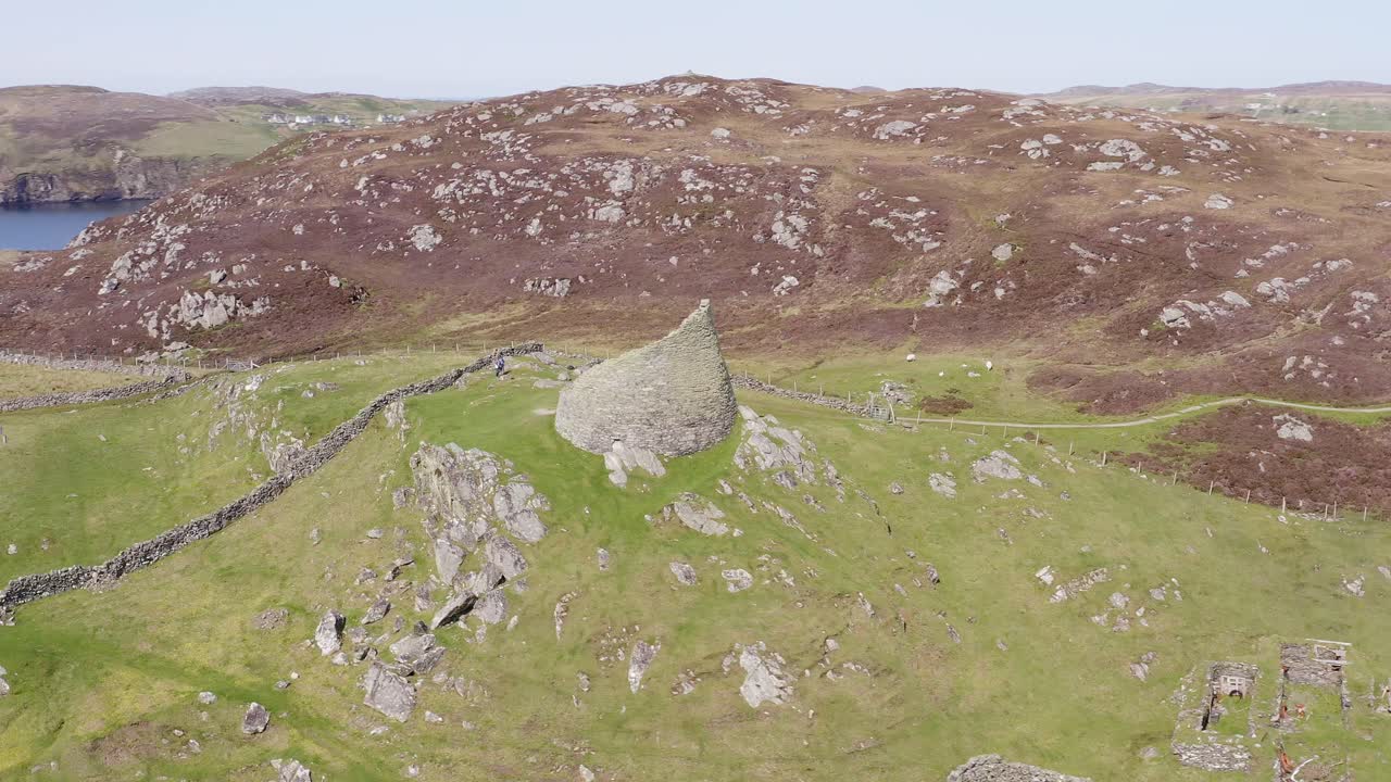 Dynamic drone shot of the 'Dun Carloway Broch' on the west coast of the Isle of Lewis, part of the Outer Hebrides of Scotland