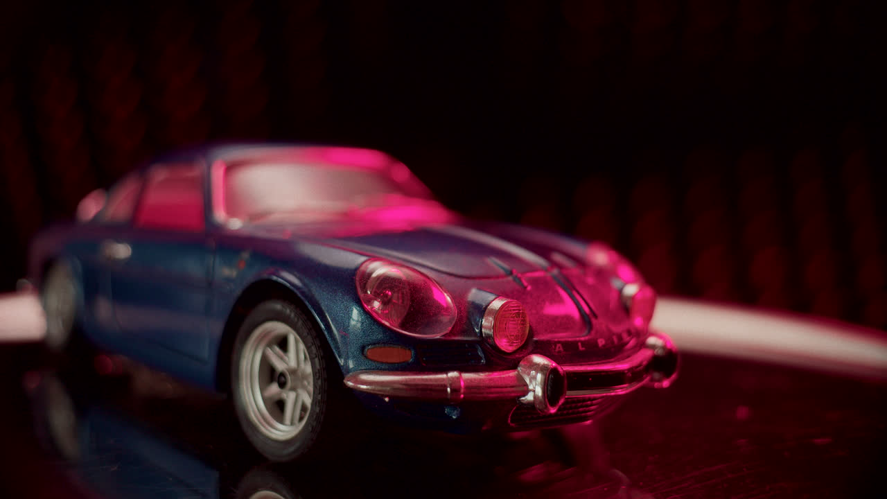 Blue Alpine A110 Model Car Under Pink Light