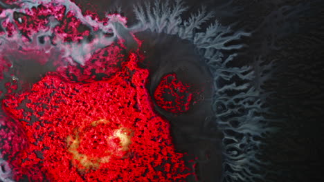 abstract ink patterns mixing in water, vibrant red and blue hues creating dynamic swirls