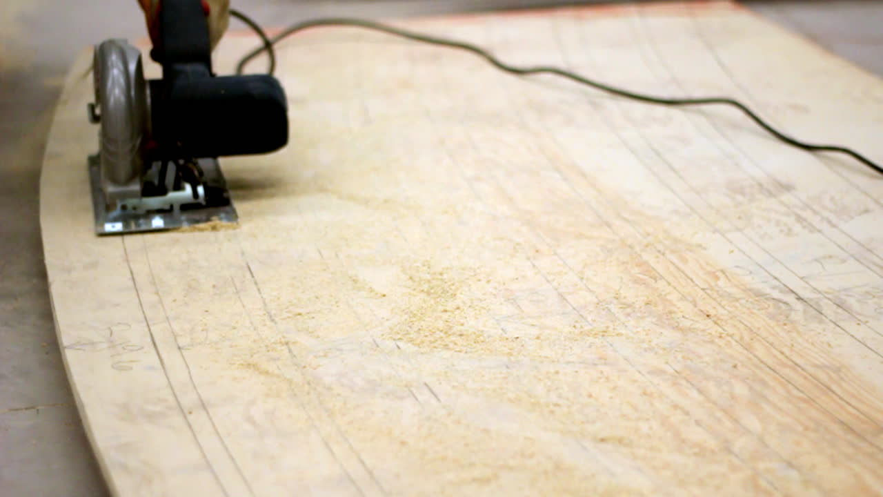 A circular saw glides along curved pencil lines, carving shapes into pale wood as fine dust scatters—capturing precision, patience, and the rhythm of craftsmanship.