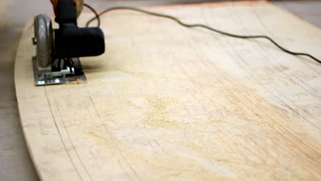 a circular saw glides along curved pencil lines, carving shapes into pale wood as fine dust scatters—capturing precision, patience, and the rhythm of craftsmanship.
