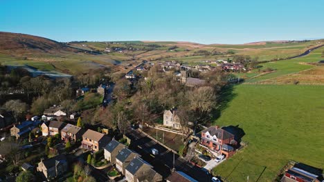 Aerial-drone-video-footage-of-the-small-village-of-Denshaw,-a-typical-rural-village-in-the-heart-of-the-Pennines