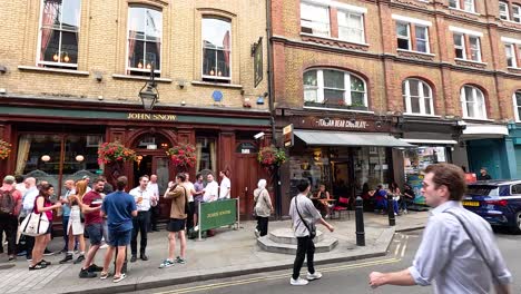 people walking and gathering near a pub