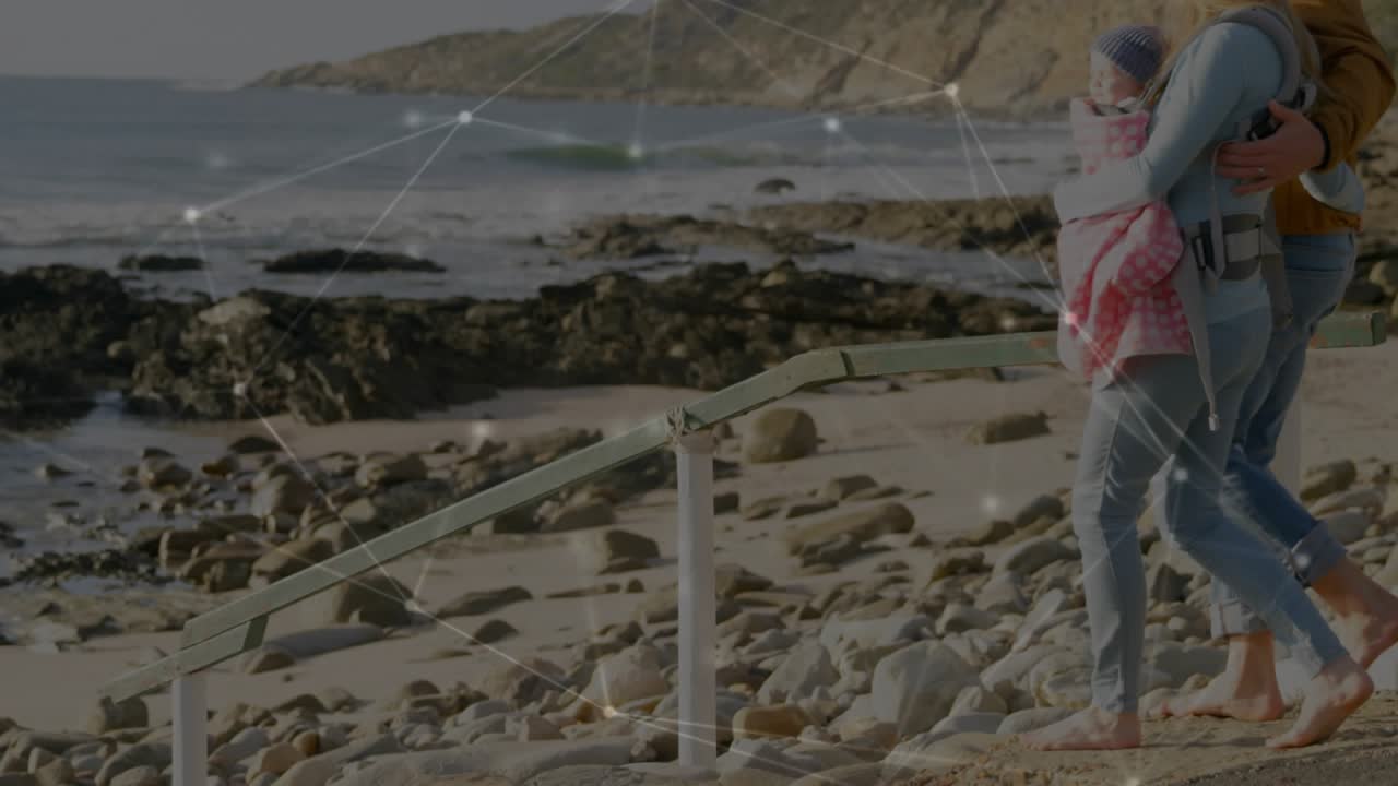Woman taking step down stairs to view pools, man steadying, tech overlay showing carrier safety
