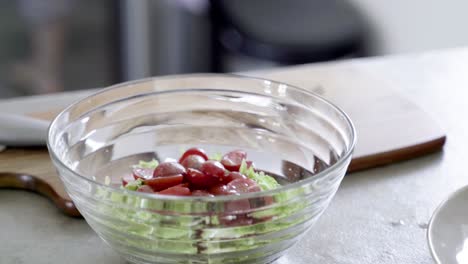 person spicing fresh vegetable salad