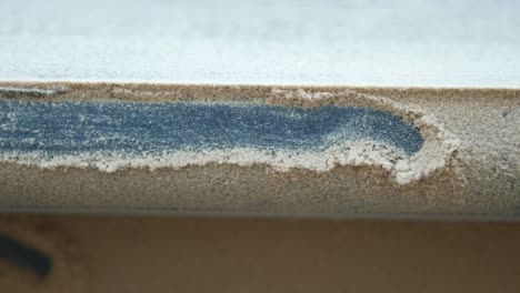 close up of sandpaper with dust