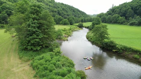 Beautiful-shot-of-tubes-and-Kayak-on-the-New-River-in-Watauga-County-NC,-North-Carolina,-Aerial-floating-down-the-river-in-summertime,-lazy-day,-weekend-fun