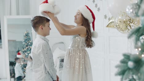 happy sister and brother hugging together in chritmas decorated house.