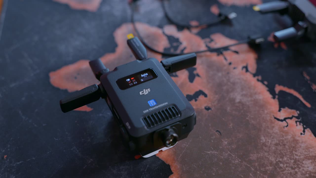 Hand Operating DJI SDR Transmission With Touchscreen. closeup shot