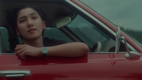 person inside a red vintage car