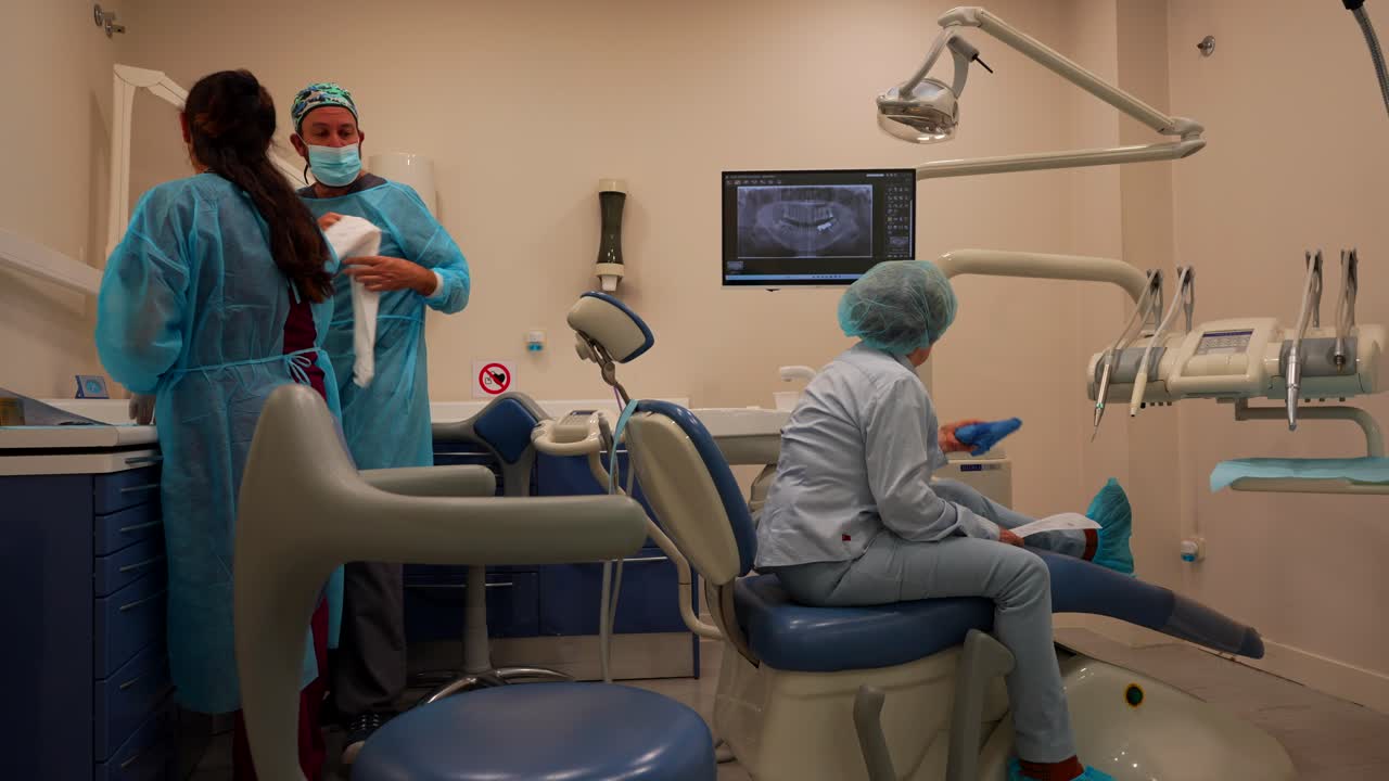 Odontologists at work and old female patient waiting on a dental chair with toothache