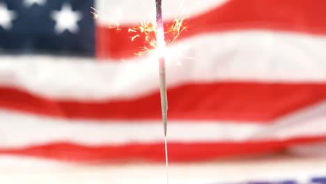 sparkler burning against american flag background