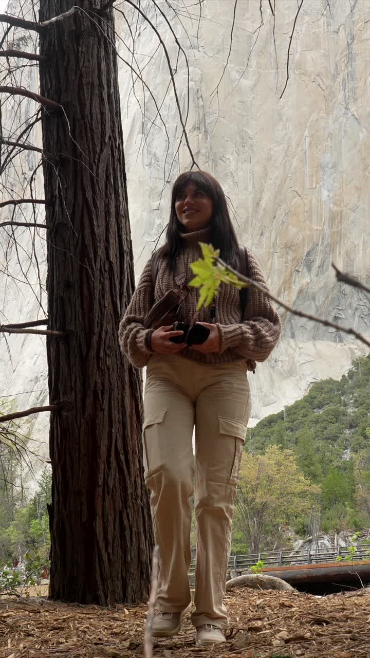 Happy Woman Exploring Nature with a Camera and Backpack